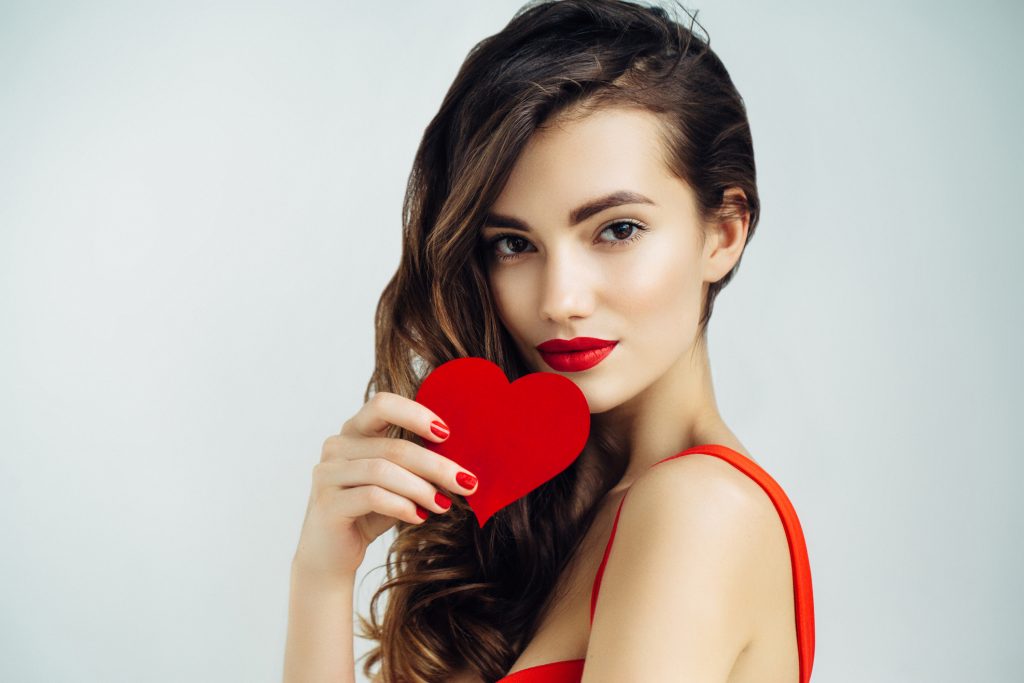 Woman holding red heart.