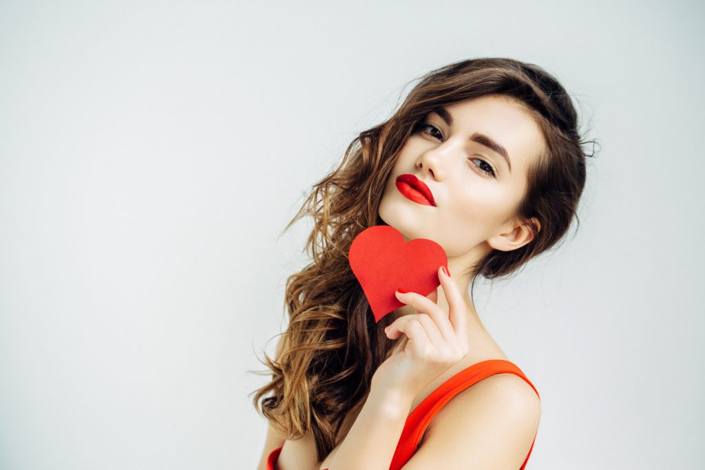 Woman holding red heart.