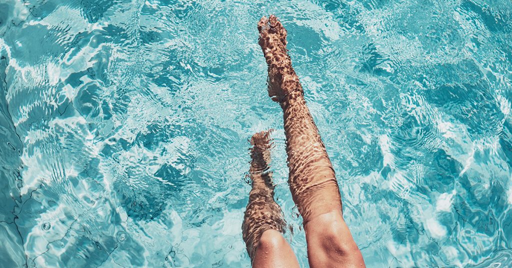 Young women's summer-ready legs in the pool in Houston, TX.