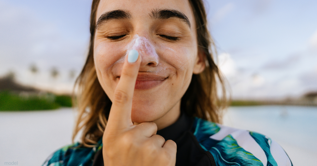 woman applying sunscreen (model)