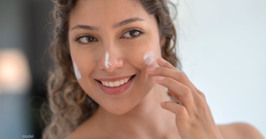 woman applying sunscreen (model)