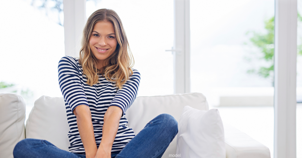 woman sitting on couch, thinking about BOTOX (model)