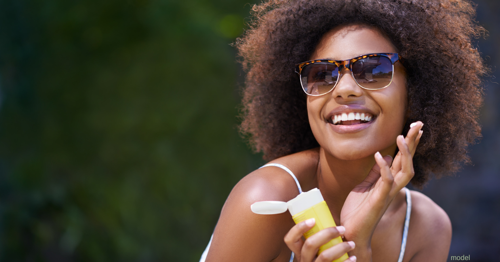 woman applying sunscreen (model)